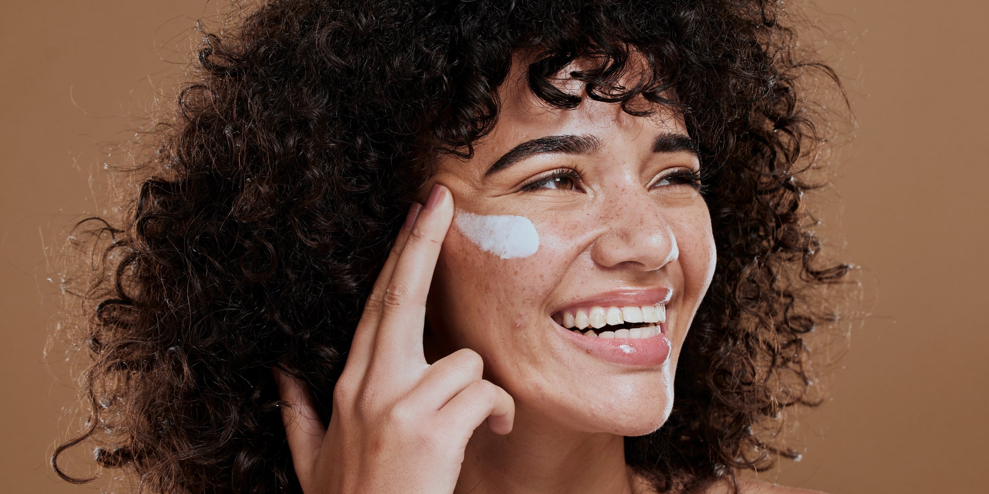 Ethnic Women applying Sunscreen